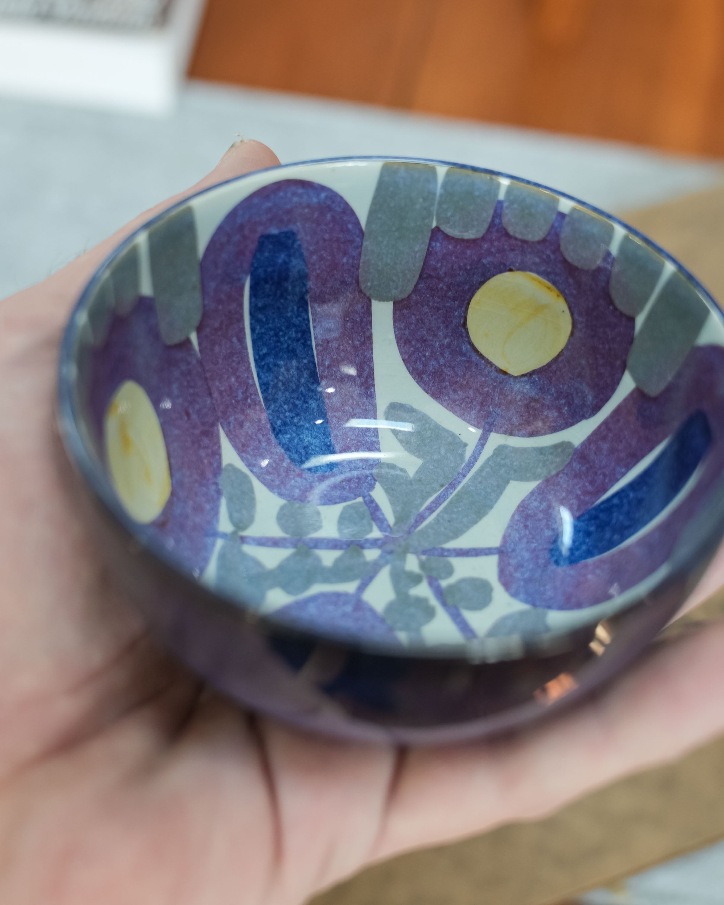 Royal Copenhagen Tenera faience bowl by Kari Christensen, held in a hand for scale