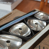 Stelton stainless steel candle holders, set of four, close view of the mark and material