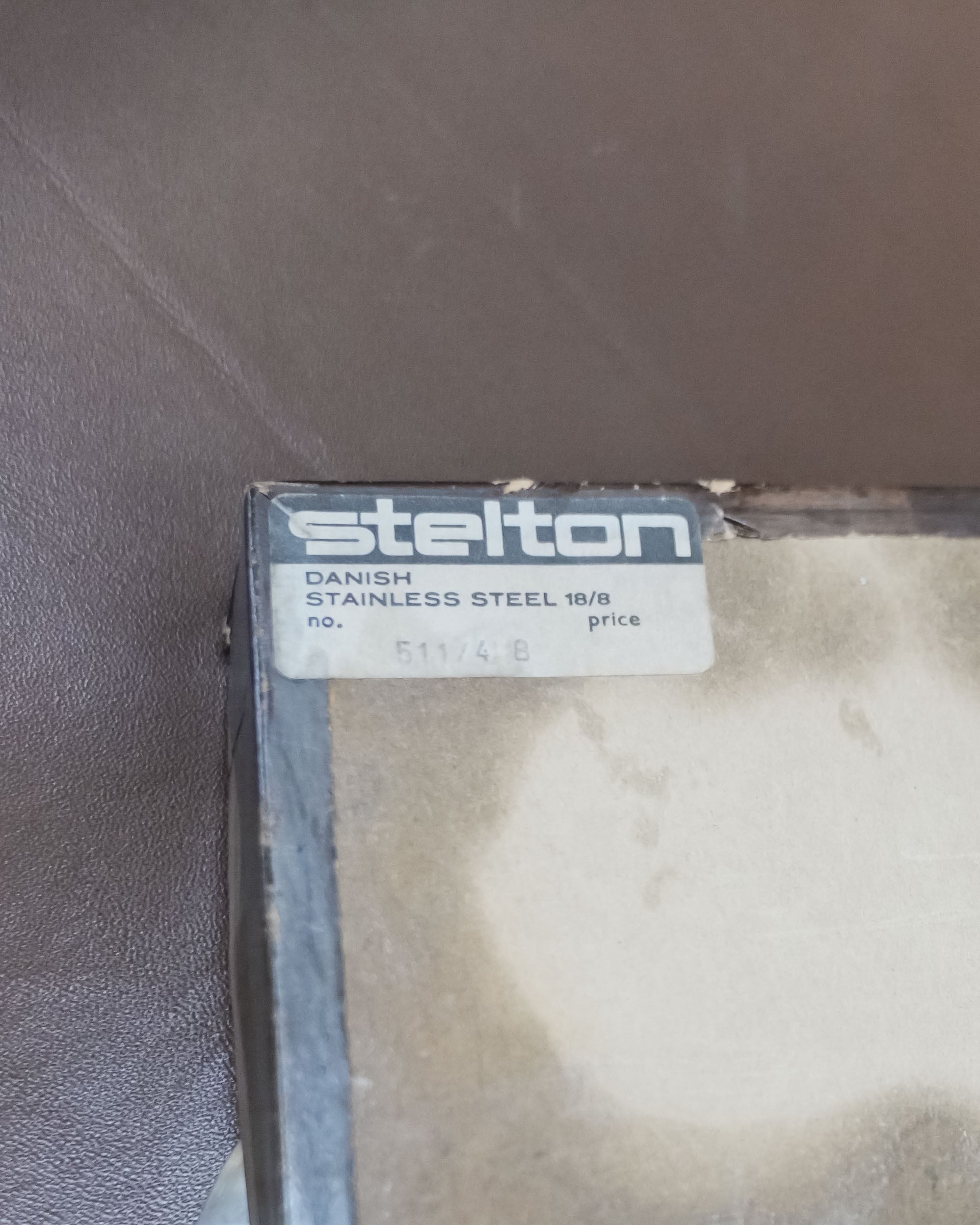 Stelton Stainless Steel Candle Holders, Set of 4, with Candles, close view of the maker's mark