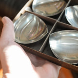 Stelton stainless steel nut dishes, set of four, held in a hand for scale