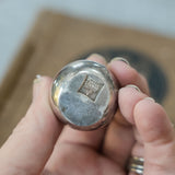 Dansk silverplate teardrop candleholders by Jens Quistgaard, close view of the mark and material