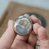 Dansk silverplate teardrop candleholders by Jens Quistgaard, held in a hand for scale