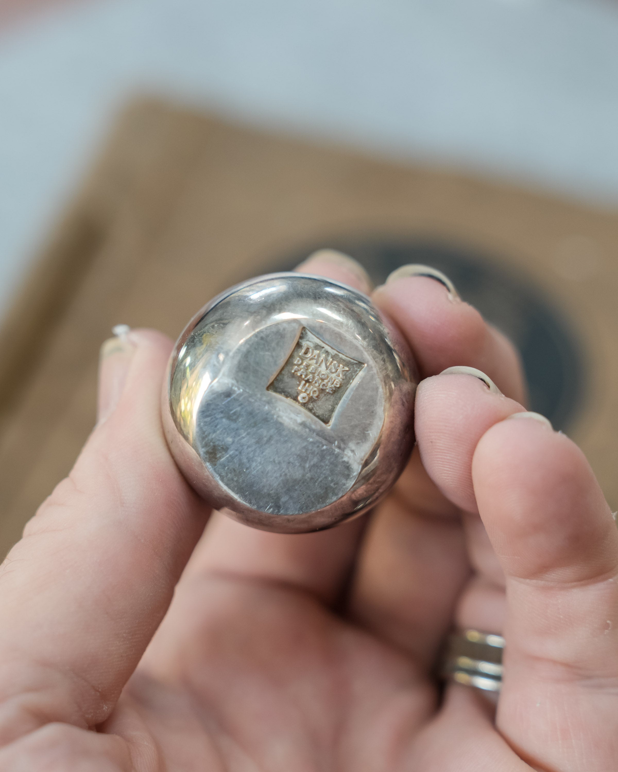 Dansk silverplate teardrop candleholders by Jens Quistgaard, held in a hand for scale