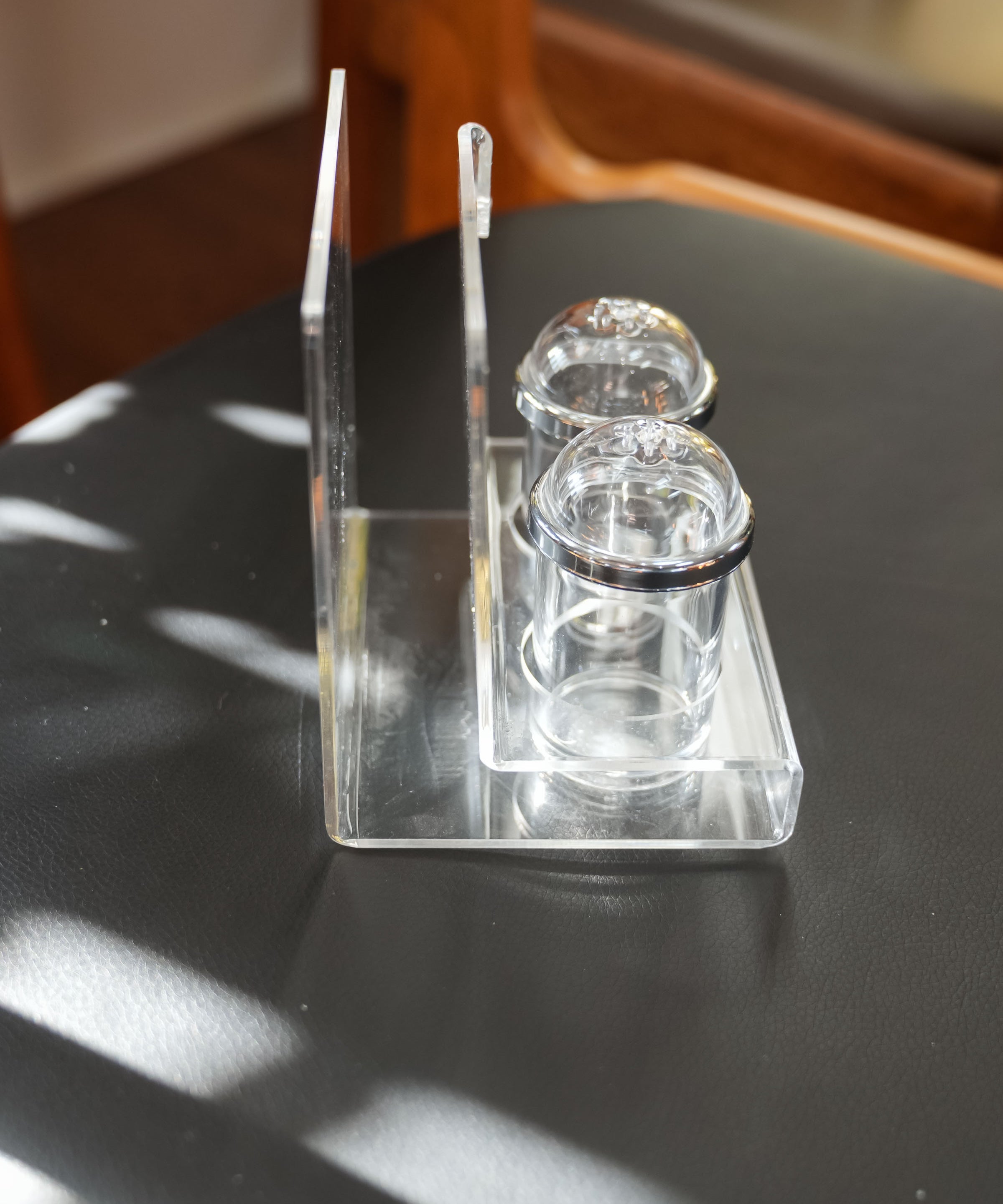 Acrylic salt and pepper shakers with napkin holder, close view of the mark and material
