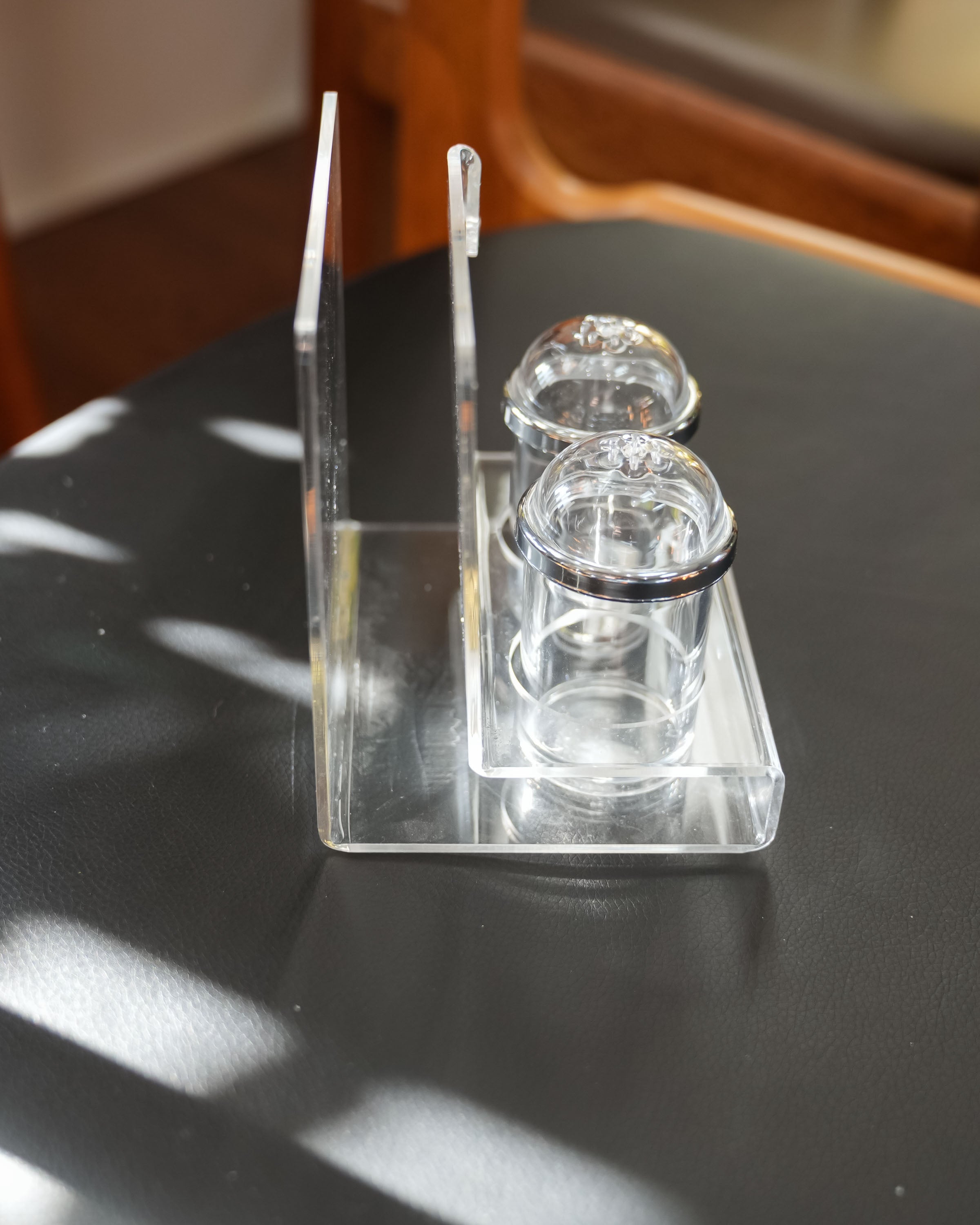 Acrylic salt and pepper shakers with napkin holder, close view of the mark and material