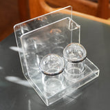 Acrylic salt and pepper shakers with napkin holder, in use