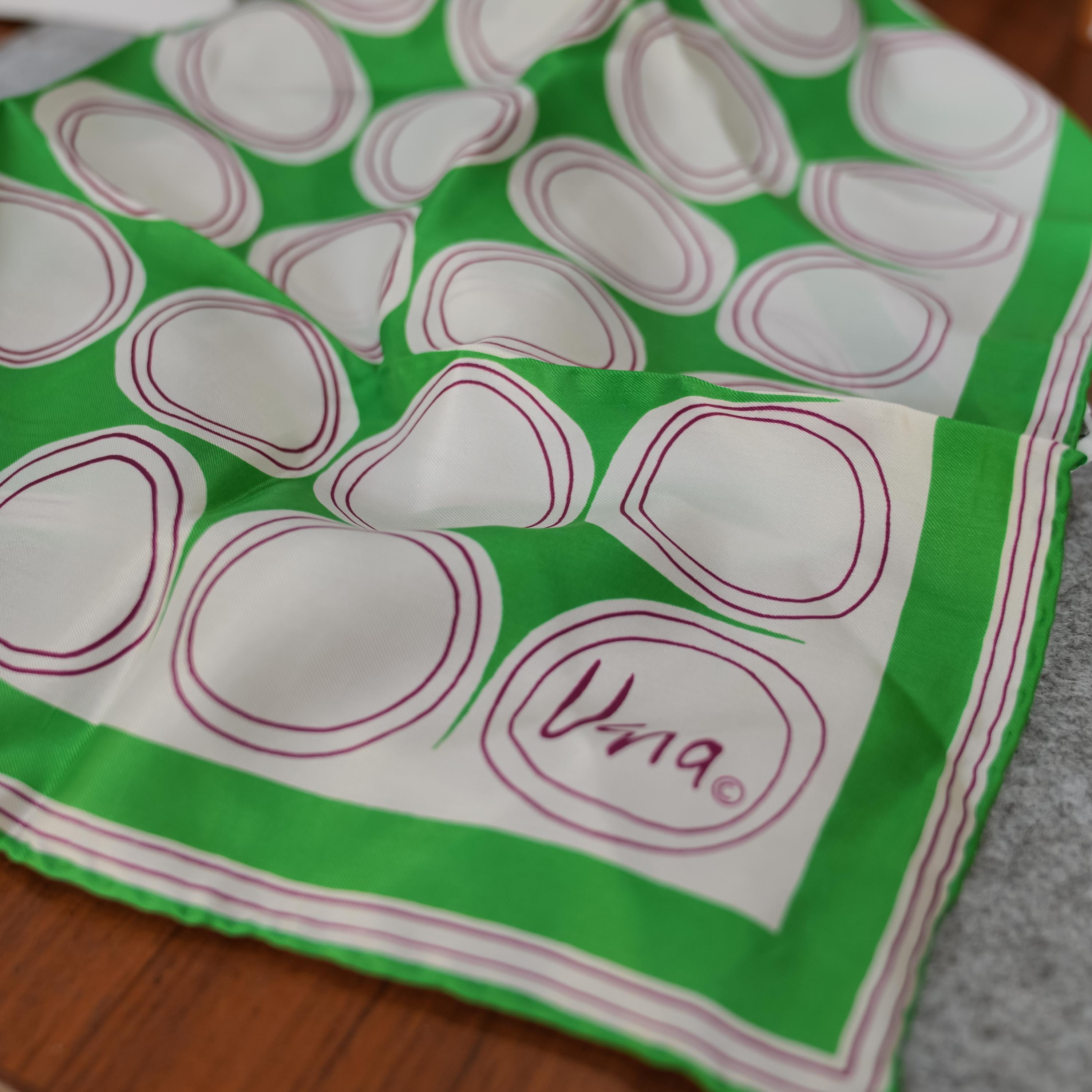 Vera scarf, green and white circles, in context on the table