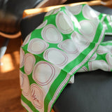 Vera scarf, green and white circles, in use