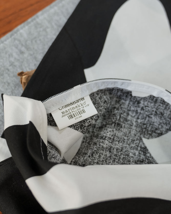 The cushion cover carries a Crate & Barrel Marimekko label.