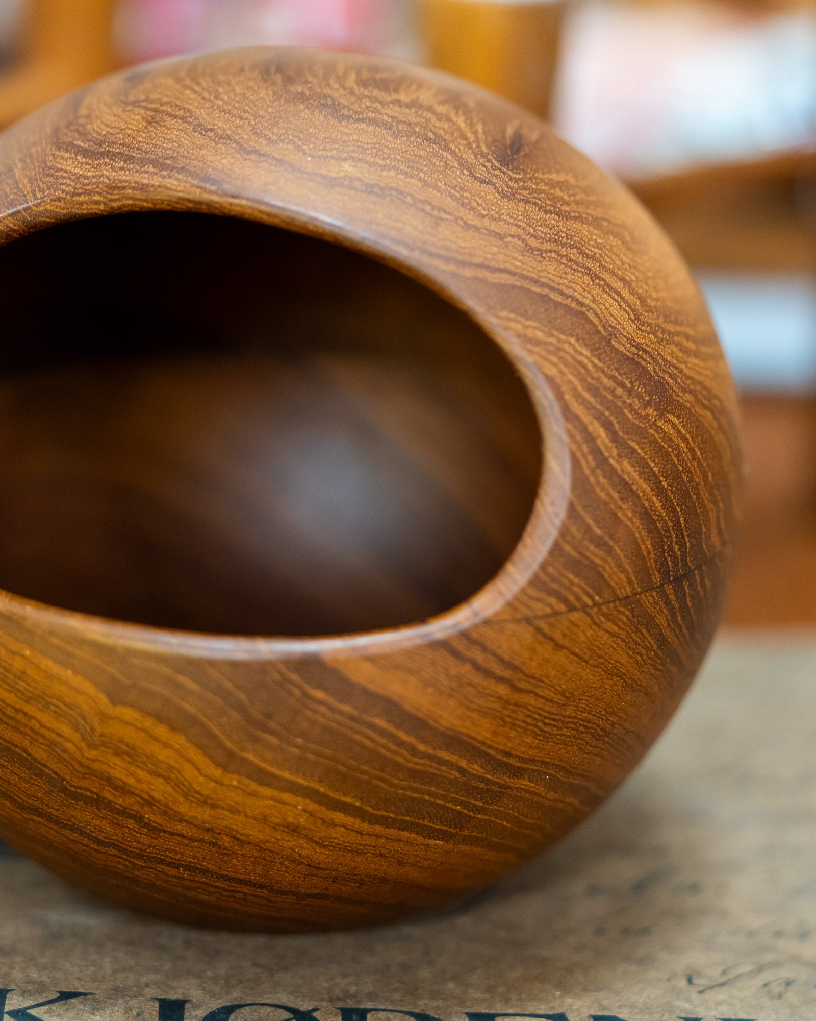 Söwe Konst teak orb nut bowl, close view of the teak grain and turned rim