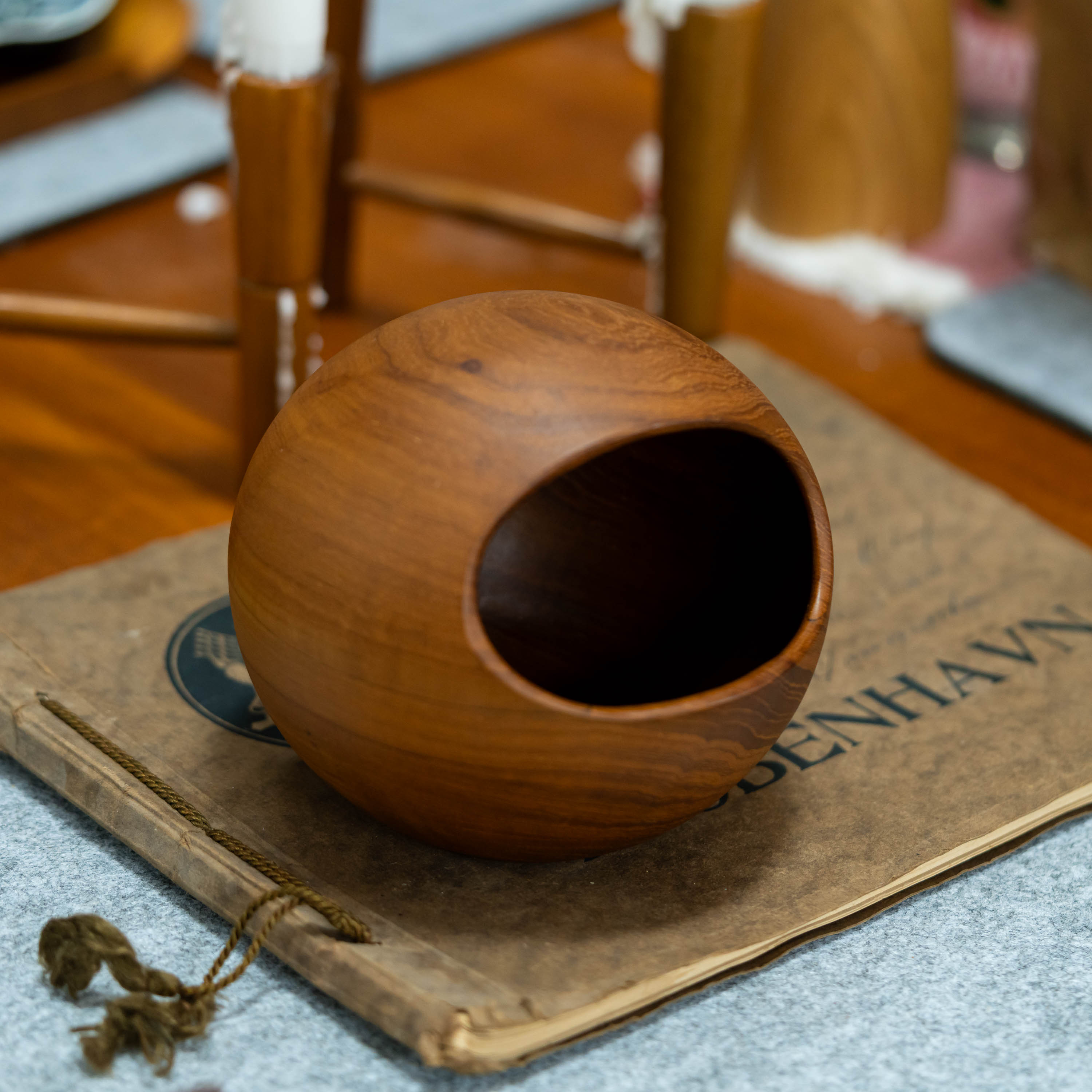 Söwe Konst teak orb nut bowl, 1960s Sweden, on a vintage Kjøbenhavn portfolio